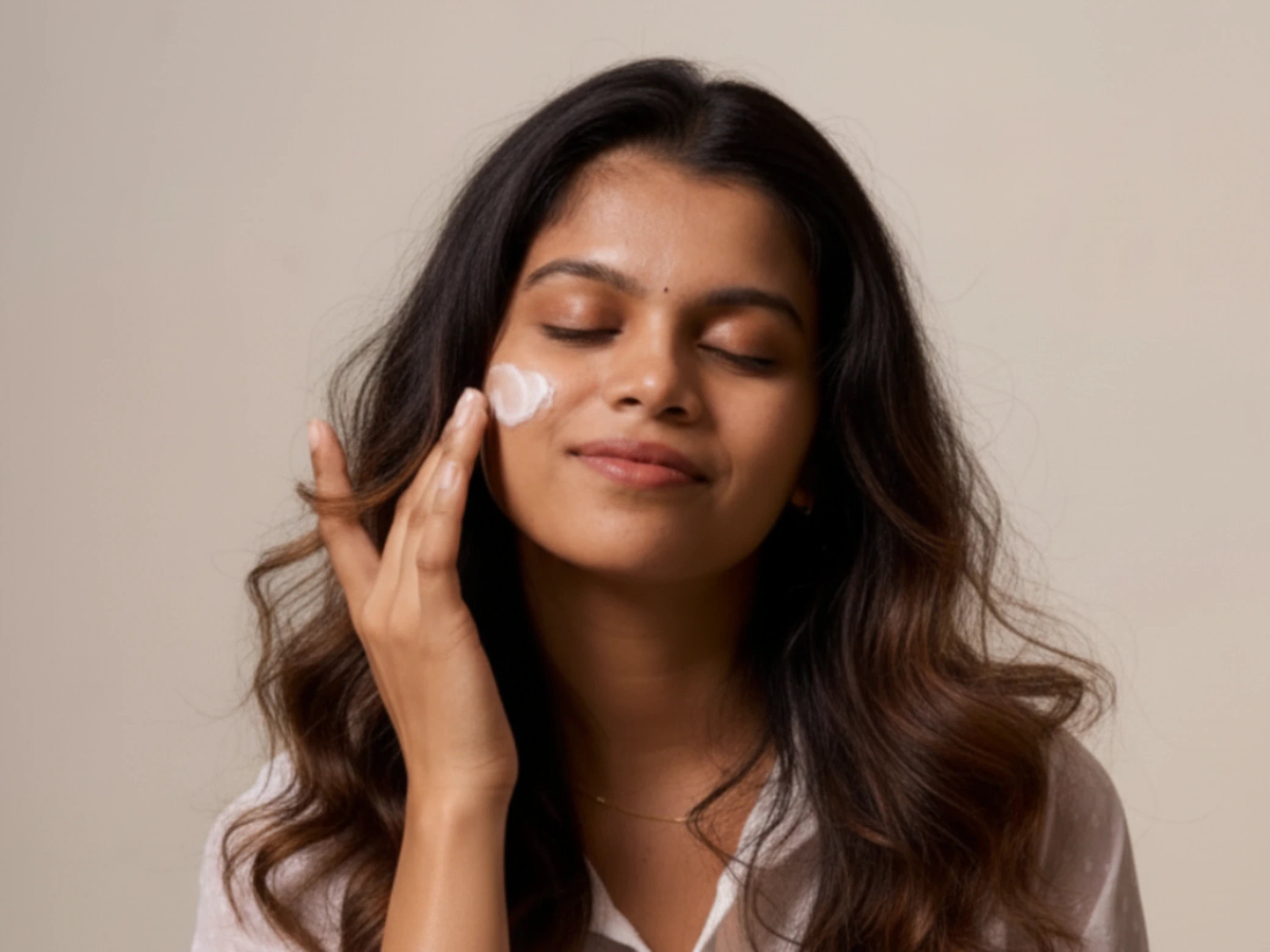Person applying skincare in natural light